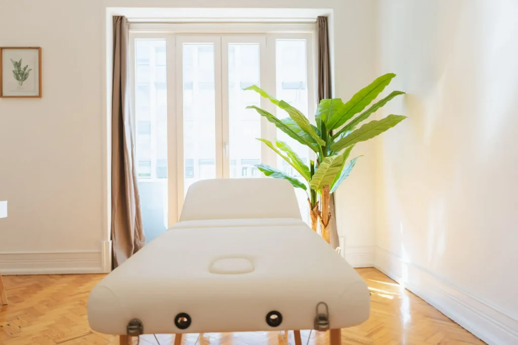 Marquesa e cortinados num gabinete de estética com luz natural, em Lisboa